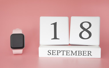 Modern Watch with cube calendar and date 18 september on pink background. Concept autumn time vacation.