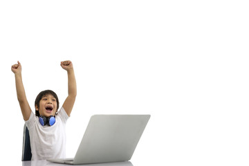 Cute boy playing laptops along with raised arms. White Background. Distance education. Network and connection. Children and learning concept. Concept of Studying at home and Technology.