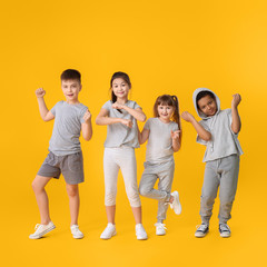 Cute little dancers on color background