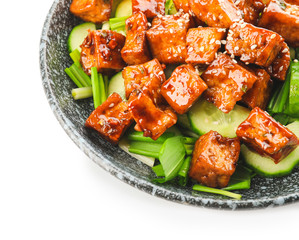 Bowl with tasty tofu cheese and vegetables on white background