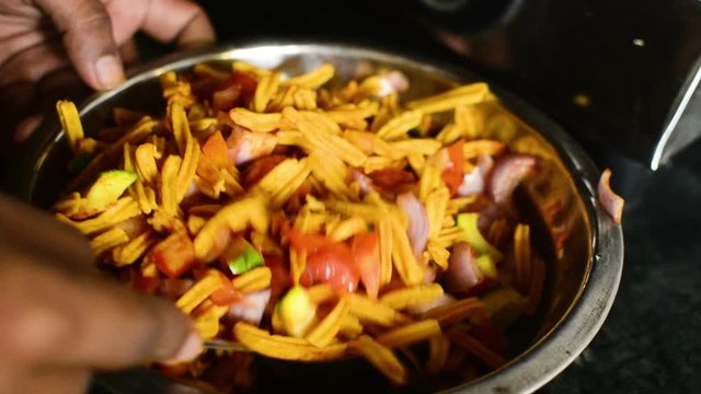 Mixing Indian Snacks to Make Bhel with Chakli, Farsan, and Vegetables