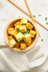 Bowl with tasty tofu cheese on white background