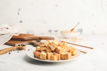 Plate with tasty tofu cheese on white background
