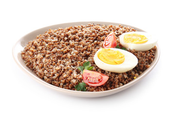 Plate with tasty buckwheat porridge, tomato and eggs on white background
