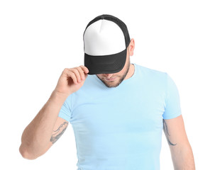 Handsome man in stylish cap on white background