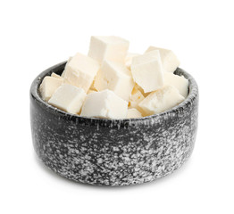Bowl with tasty cut feta cheese on white background