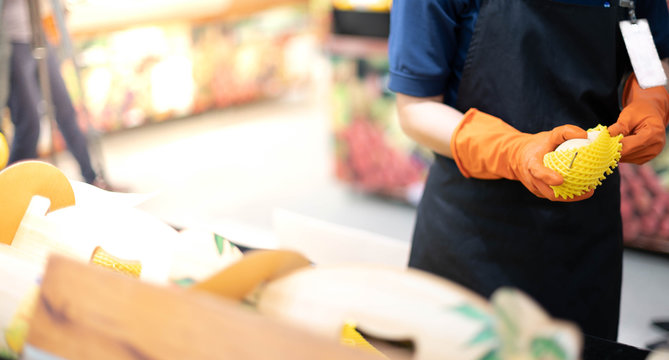 Female hand holding  and arranging fresh mango fruit in the tray prepare for customer choose and buy for eat.