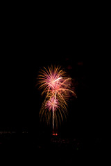 Explosive colorful fireworks display celebrating the fourth of July holiday leaving room for copy..