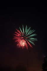 Explosive colorful fireworks display celebrating the fourth of July holiday leaving room for copy..