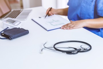 Professional medical doctor in white uniform gown coat interview consulting patient.