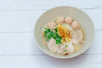 Thai Breakfast, Hot Thai rice soup with pork and meat on bowl with white wood background