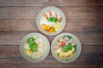 Top view composition with Thai Food. Congee shrimp, Thai Rice Soup and Clear Soup with Tofu and Minced Pork