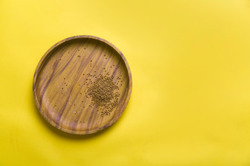 Theme of diet and weight loss on a white background. buckwheat on a wooden plate. Slow carbs on a yellow background with a copy of space. stay at home in self isolation