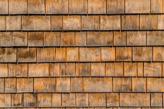 Closeup of brown rustic shake and shingle siding on an old house in Annapolis Maryland - Powered by Adobe