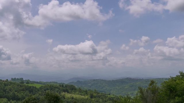 White Running Clouds Over The Hills - a time lapse during a typical windy day in a particular hilly Italian landscape