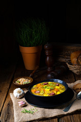 Rustic pea soup with bacon and sausages