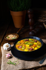 Rustic pea soup with bacon and sausages