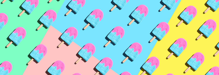 Pink and blue popsicles with shadow - overhead view