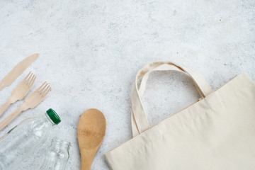 Reusable shopping bag, glass jars, wooden kitchen accessories on light background. Zero waste, eco friendly concept. Top view, flat lay, copy space