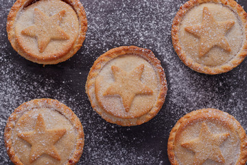Flat lay image of some mince pies,which have been dusted with icing sugar.