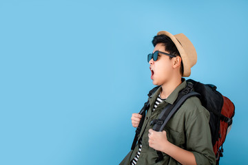 Tourists wearing black sunglasses feel happy, shocked and surprised on the blue background in the studio.