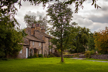An old English cottage house is part of the serene landscape of Downham village, England.