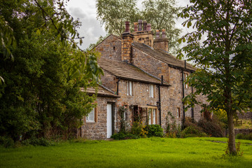 Fototapeta na wymiar Stone cottages are part of the enduring charm of Downham Village, England.