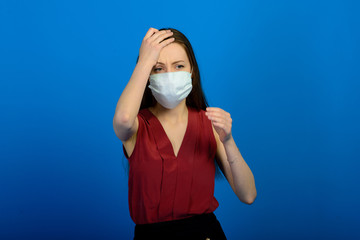 Girl in protective medical mask and blue gloves on blue background. close-up portrait of a woman in a transparent mask.