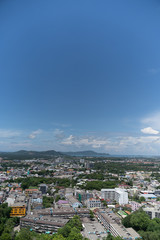 Fototapeta na wymiar panoramic scene at Khao Rung Phuket viewpoint hilltop, home , building and green tree. Sea and mountain long distance, beautiful cloudy blue sky background at day time, nature and travel concept..