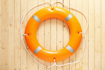 Lifebuoy ring on wooden background