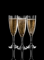 Glasses of champagne on dark background