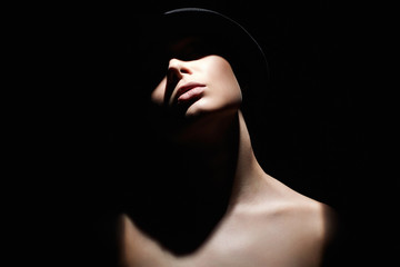 Beautiful woman in hat. Girl with face under Shadow