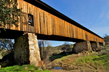 The 19th century Knight's Ferry Bridge is a historic covered bridge spanning the Stanislaus River...