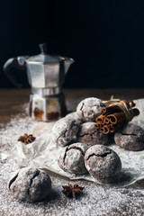 A few marble brown cookies with star anise, cinnamon, coffee pot and powdered sugar