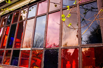 Window made of colored glass. stained glass window of a country house. red and blue glass. stained glass with your own hands for the cottage