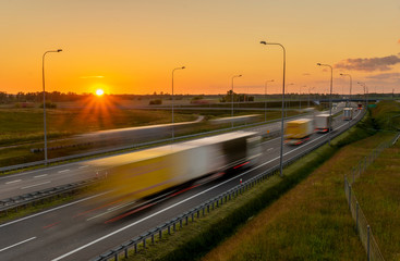 Fototapeta na wymiar heavy truck traffic on the highway in the evening