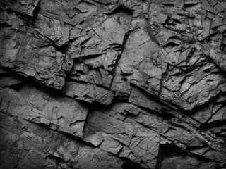 Black and white background. Black grunge background. Rock texture. Close-up.	