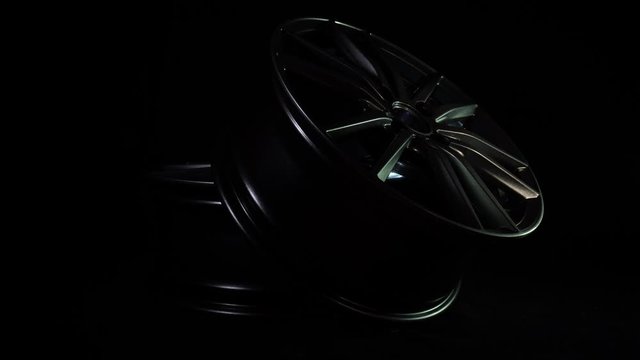 Modern alloy wheels for car in dark background. New metal equipment for auto and vehicle. Luxury design. Expensive bright steel disks made of carbon. Clean aluminium magnesium wheels stand. Cast drive