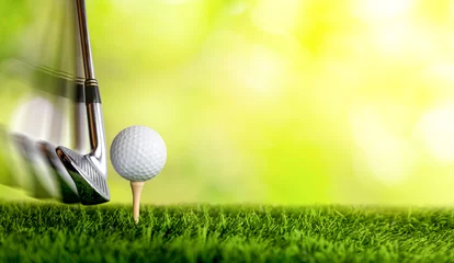 Poster Slow motion of golf club hitting golf ball on tee. © Muhammadsainudin