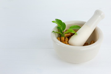 Herbal supplement in capsules with healthy medicinal plant.Alternative drug or natural pharmaceutical capsule.Medication of vitamin supplemental for care and treatment.