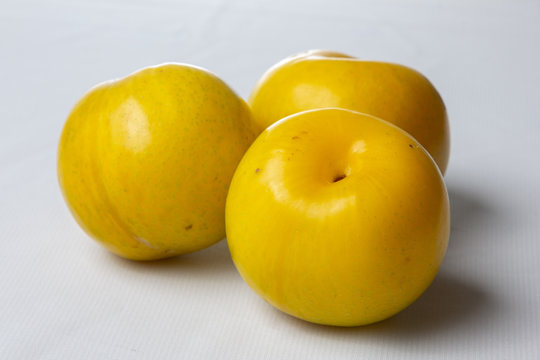 Yellow plums on light background