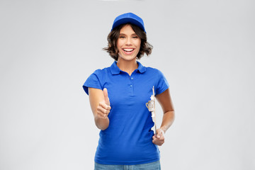 mail service and shipment concept - happy smiling delivery girl in blue uniform with clipboard over...