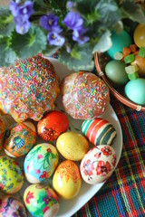colored easter eggs and easter cake on table