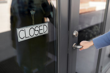 small business, pandemic and service concept - hand trying to open closed office door