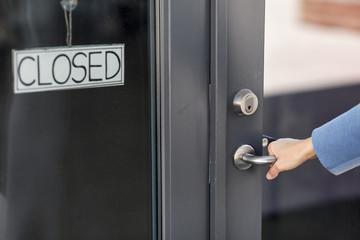 small business, pandemic and service concept - hand trying to open closed office door
