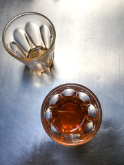 2 Transparent glass of teas on silver aluminium table background, Close up & Macro shot, Selective focus, About drink concept