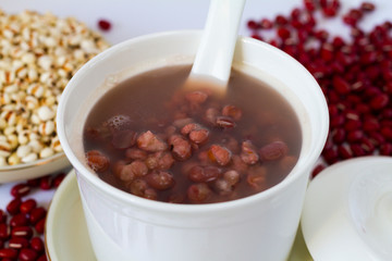 Job's tears, or adlay millet and red beans soup porridge in a bowl close up