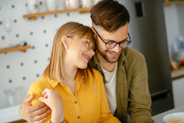 Young couple making breakfast at home. Loving couple enjoying in morning..	
