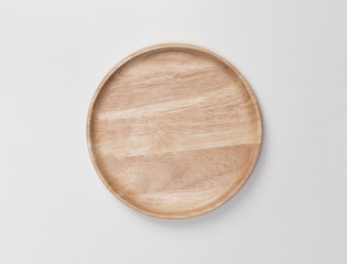 Empty blank wooden round plate or dish isolated on white background with shadow, Top view of traditional handcrafted kitchenware concept