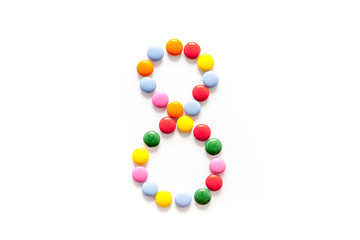 Number 8 - eight - lined with sweets on isolated top-down